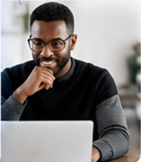 Smiling man reviewing a draft on his laptop